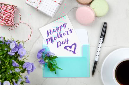 Canva - Happy Mothers Day Card Beside Pen, Macaroons, Flowers, and Box Near Coffee Cup With Saucer